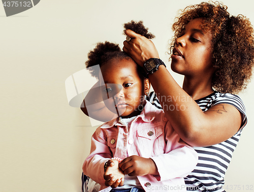 Image of adorable sweet young afro-american mother with cute little daughter, hanging at home, having fun playing smiling, lifestyle people concept 