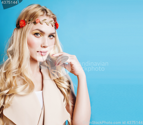 Image of young blond woman dressed like ancient greek godess,  jewelry close up isolated, beautiful girl hands manicured red nails on blue background