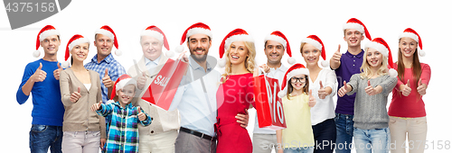 Image of people in santa hats with sale sign at christmas