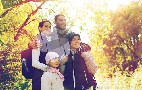 Image of happy family with backpacks hiking