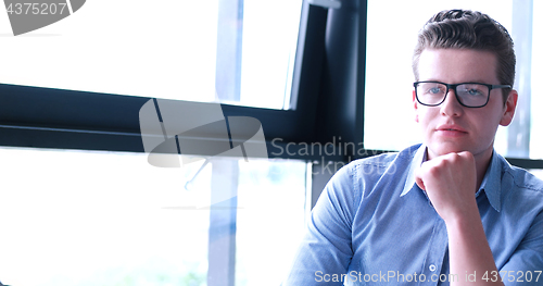 Image of young businessman in startup office