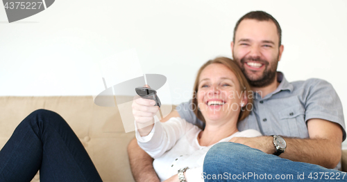 Image of senoior couple watching tv in modern villa