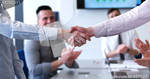 Image of cloasing the deal in modern office interior