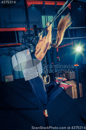 Image of Concept: power, strength, healthy lifestyle, sport. Powerful attractive muscular woman at CrossFit gym