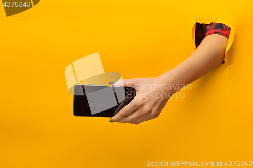 Image of female teen hands using phone with black screen, isolated