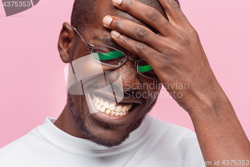 Image of Black man holding his head in pain and depression