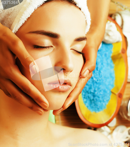 Image of stock photo attractive lady getting spa treatment in salon, close up asian hands on face