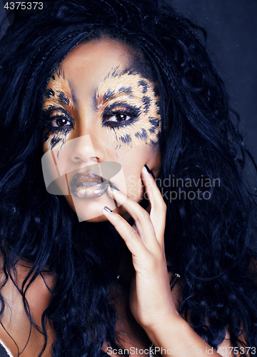 Image of beauty afro girl with cat make up, creative leopard print closeu