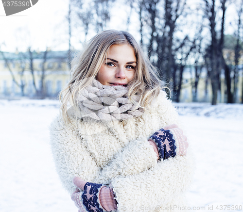 Image of young pretty teenage hipster girl outdoor in winter snow park having fun drinking coffee, warming up happy smiling, lifestyle people concept