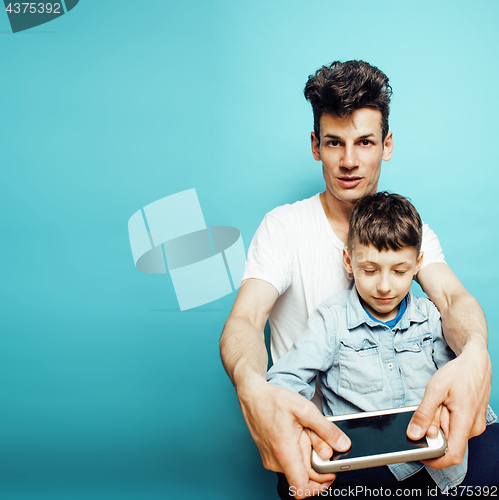 Image of young pretty man model with little cute son playing together, lifestyle modern people concept, family male close up