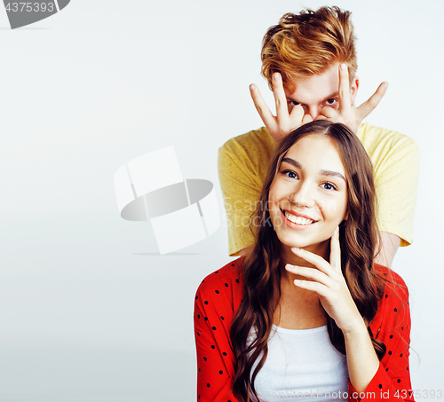 Image of young pretty teenage couple, hipster guy with his girlfriend happy smiling and hugging isolated on white background, lifestyle people concept 