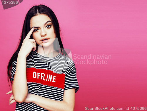 Image of young pretty teenage woman emotional posing on pink background, fashion lifestyle people concept 