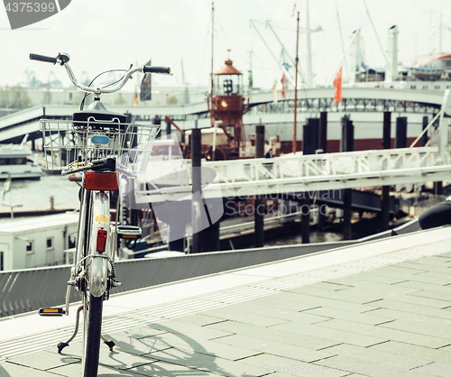 Image of postcard view of Hamburg harbour, parking bicycle at the shore