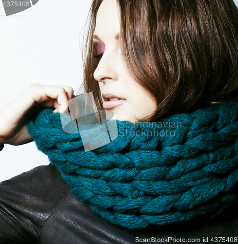 Image of young pretty real woman in sweater and scarf all over her face s