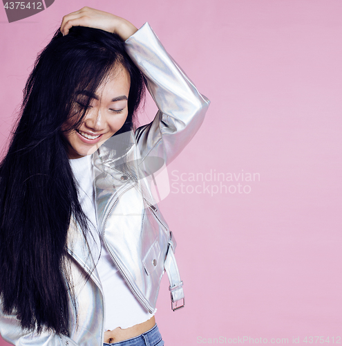 Image of young pretty smiling asian korean girl wearing modern fashion clothers on pink background, lifestyle people concept 