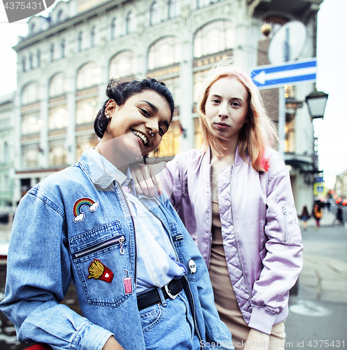 Image of Two teenage girls infront of university building smiling, having fun, lifestyle real people concept 