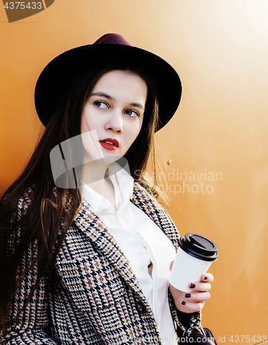 Image of young pretty hipster girl student with coffee cup posing adorable smiling, lifestyle people concept outdoor 