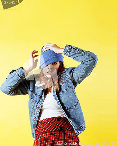 Image of lifestyle people concept: pretty young school teenage girl having fun happy smiling on yellow background 