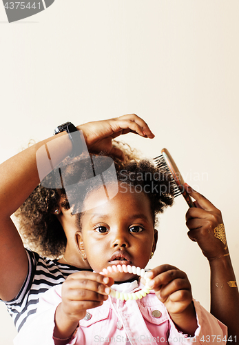 Image of adorable sweet young afro-american mother with cute little daughter, hanging at home, having fun playing smiling, lifestyle people concept, happy smiling modern family 