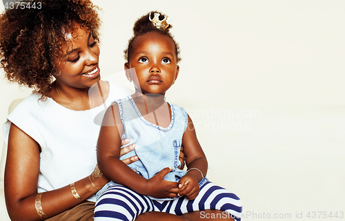 Image of adorable sweet young afro-american mother with cute little daughter, hanging at home, having fun playing smiling, lifestyle people concept, happy smiling modern family 