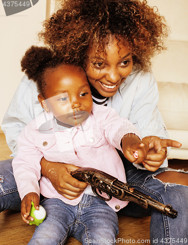 Image of adorable sweet young afro-american mother with cute little daughter, hanging at home, having fun playing smiling, lifestyle people concept, happy smiling modern family 