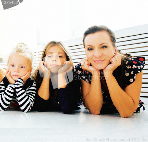 Image of Mature sisters twins at home with little daughter, happy family 