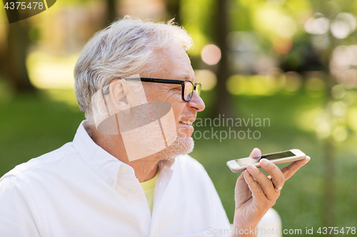 Image of old man using voice command recorder on smartphone