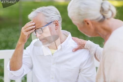 Image of senior man suffering from headache outdoors