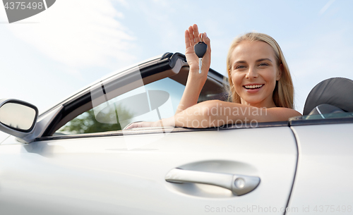 Image of happy young woman with convertible car key