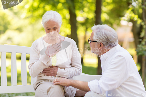 Image of senior woman feeling sick at summer park