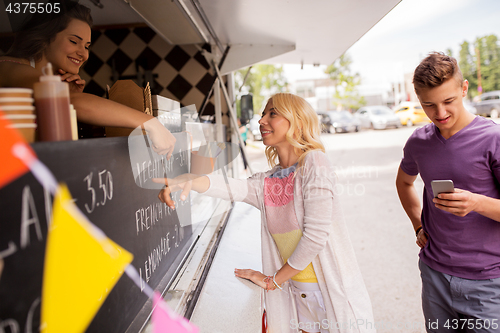 Image of happy customers queue at food truck