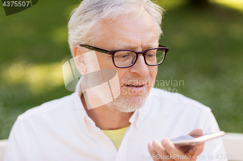 Image of old man using voice command recorder on smartphone