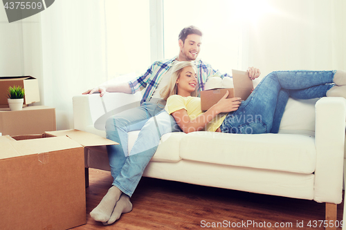 Image of happy couple with big cardboard boxes at new home