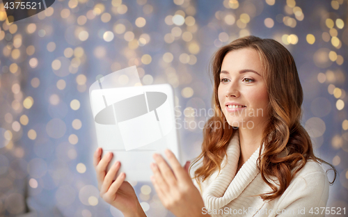 Image of happy young woman with tablet pc at home