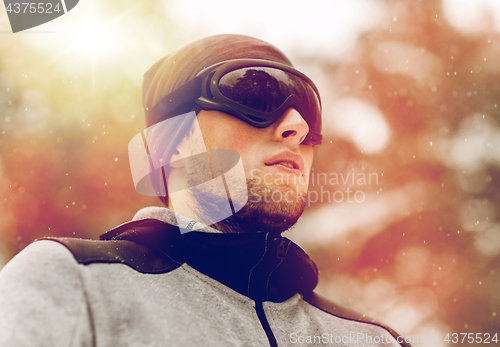 Image of sports man with ski goggles in winter outdoors