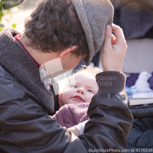 Image of Father with cheerful child in the park.