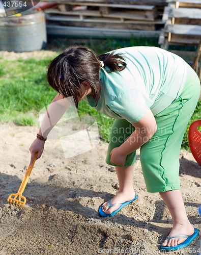 Image of Girl Playing In Sand