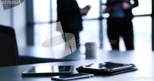 Image of tablet, mobile cell phone and cup of coffee  in office with busi