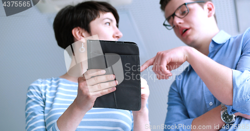 Image of low angle shot of business people using technology