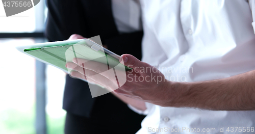 Image of low angle shot of business people using technology