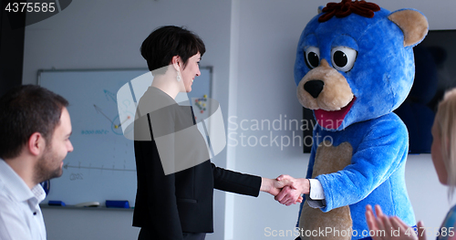 Image of boss dresed as bear having fun with business people in trendy of