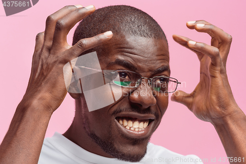 Image of Black man holding his head in pain and depression