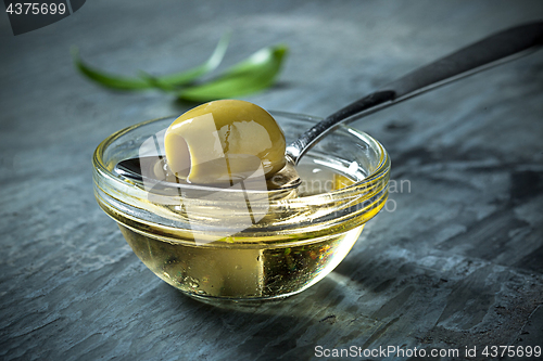 Image of Olive oil and olive branch on the wooden table