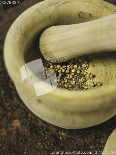 Image of spices in a wooden bowl or mortar