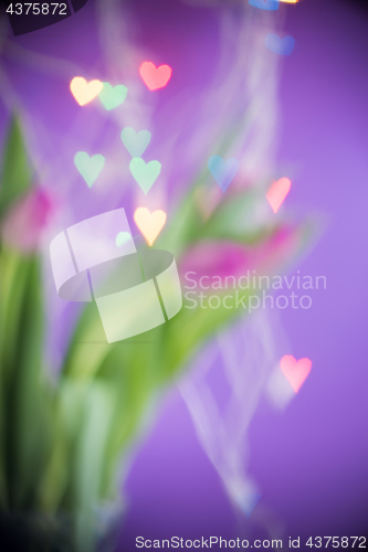 Image of Defocused tulips and bokeh light hearts