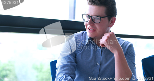 Image of young businessman in startup office