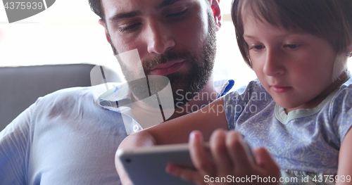 Image of Father Daughter using Tablet in modern apartment