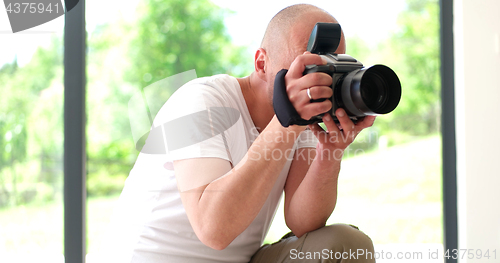 Image of Photographer takes pictures with DSLR camera