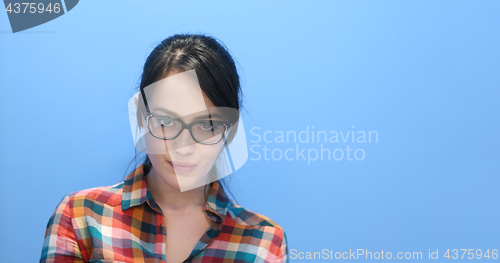 Image of woman smiling wearing on a pair of large glasses