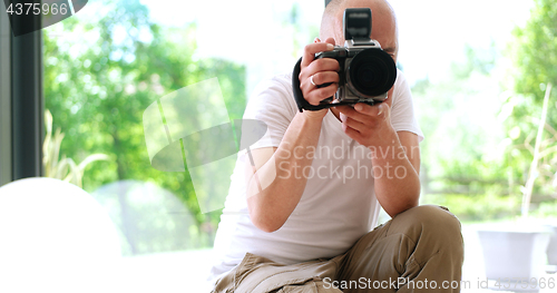 Image of Photographer takes pictures with DSLR camera